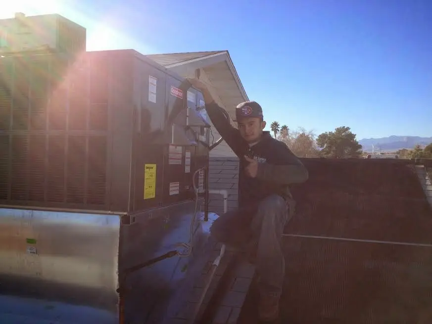 HVAC technician performing HVAC Inspection on a rooftop unit in Sweet Home